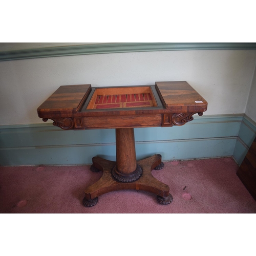 276 - An early Victorian rosewood games table, with reversible central section, on a tapering column, with... 