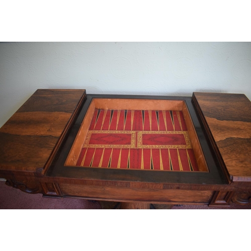 276 - An early Victorian rosewood games table, with reversible central section, on a tapering column, with... 