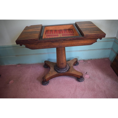 276 - An early Victorian rosewood games table, with reversible central section, on a tapering column, with... 