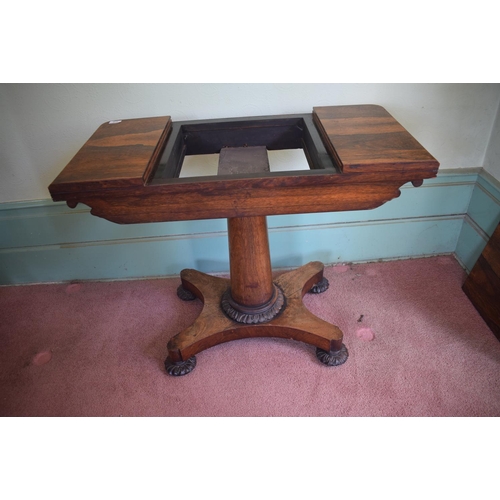 276 - An early Victorian rosewood games table, with reversible central section, on a tapering column, with... 