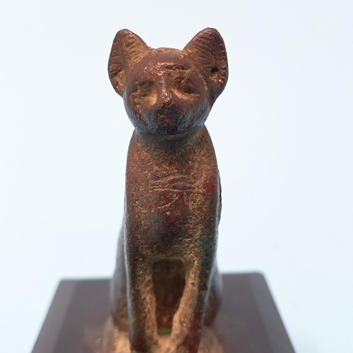 292 - A bronze Egyptian style cat, 6 cm high, on marble base