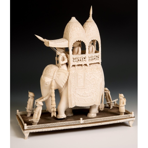 295 - A late 19th century carved ivory elephant, carrying a howdah, carrying two figures escorted by four ... 