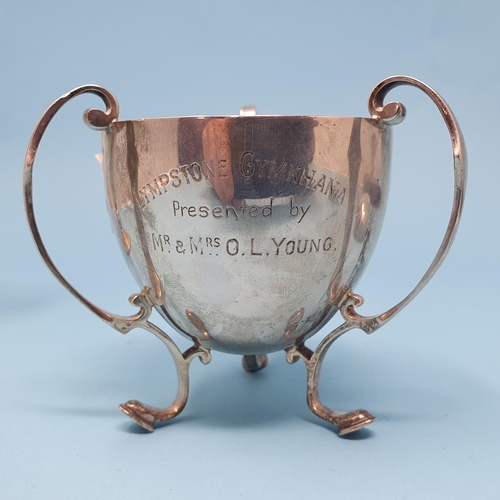 297 - A George V silver tyg, raised on three feet, Sheffield 1929, a silver coloured metal vase, six tea k... 