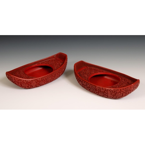 299 - A pair of Chinese red cinnabar lacquer stands, of shoe form, 19 cm wide, removal cost A