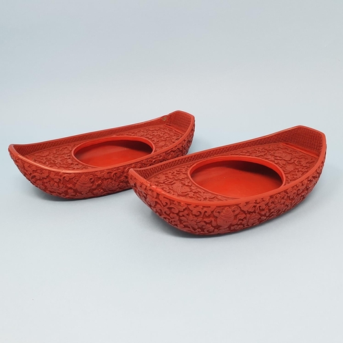 299 - A pair of Chinese red cinnabar lacquer stands, of shoe form, 19 cm wide, removal cost A