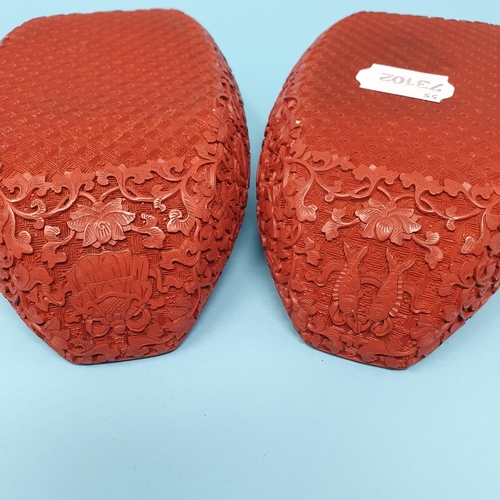 299 - A pair of Chinese red cinnabar lacquer stands, of shoe form, 19 cm wide, removal cost A