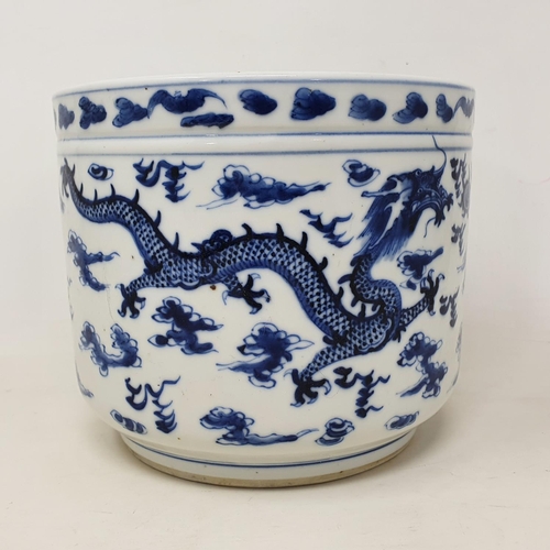 302 - A Chinese blue and white jardiniere, decorated dragons chasing a flaming pearl, 14 cm high, removal ... 