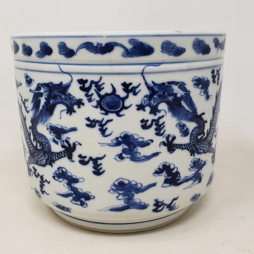 302 - A Chinese blue and white jardiniere, decorated dragons chasing a flaming pearl, 14 cm high, removal ... 