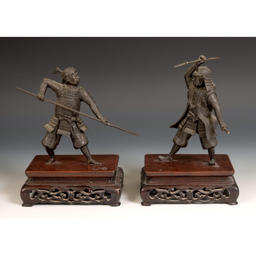 314 - A Japanese bronze Samurai, holding a katana, on a carved and pierced hardwood stand, Meiji period, 2... 