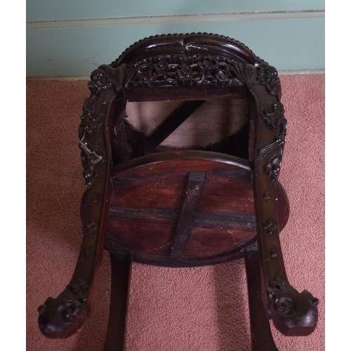 318 - A Chinese hardwood two tier jardiniere stand, of shaped circular form, with a marble inset top, abov... 