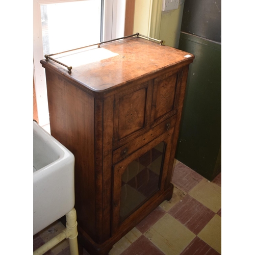 32 - A late Victorian inlaid burr walnut music cabinet, having a pair of panel doors above a drawer, with... 