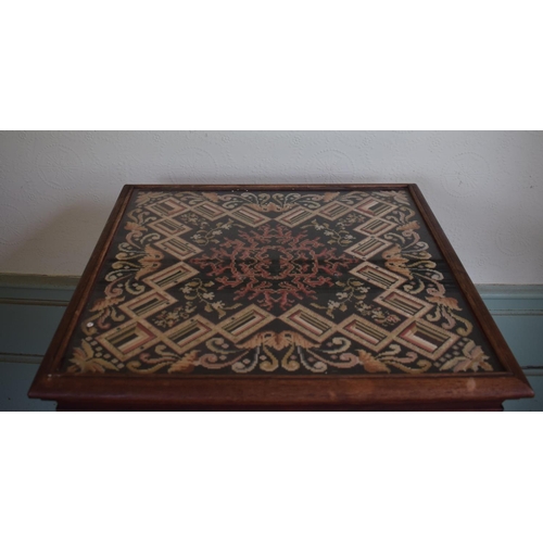 343 - A rosewood occasional table, the top inset a needlework panel, on a barley twist column, 53 cm wide,... 