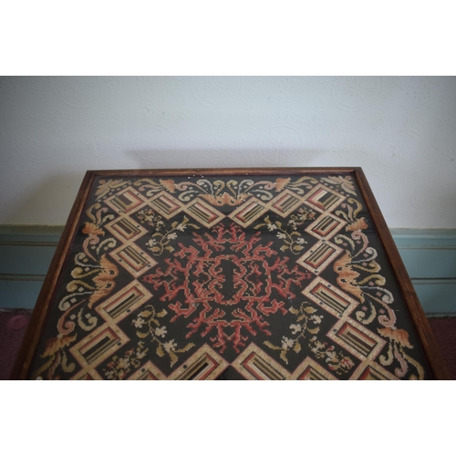 343 - A rosewood occasional table, the top inset a needlework panel, on a barley twist column, 53 cm wide,... 