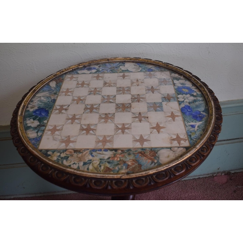 345 - A Victorian occasional table, the circular tilt top inset a panel painted for chess, and with foliag... 