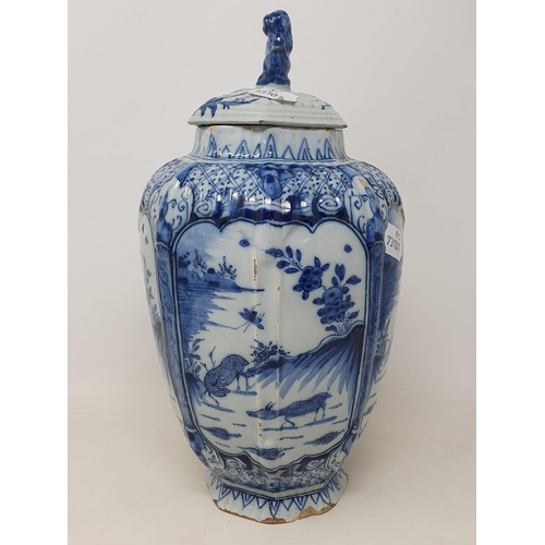 351 - A 19th century Dutch Delft vase and associated cover, of octagonal baluster form, decorated deer, in... 