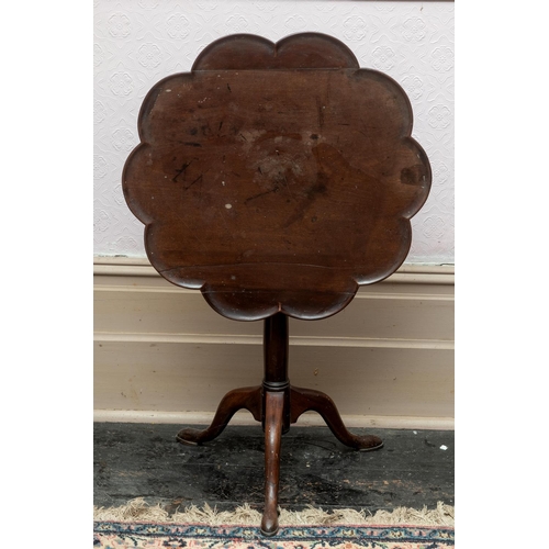 358 - A George III mahogany tripod table, the dished lobed top on a birdcage support, a tapering column an... 