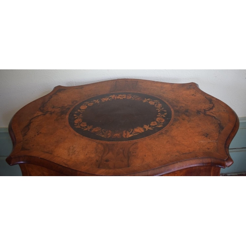 365 - A late 19th century occasional table, of shaped oval form, veneered in walnut and with floral marque... 