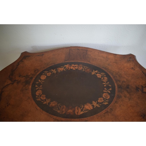 365 - A late 19th century occasional table, of shaped oval form, veneered in walnut and with floral marque... 