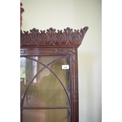 369 - An 18th century style Chippendale display cabinet, the cornice carved leaves, having a pair of bar g... 