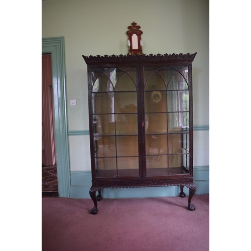 369 - An 18th century style Chippendale display cabinet, the cornice carved leaves, having a pair of bar g... 