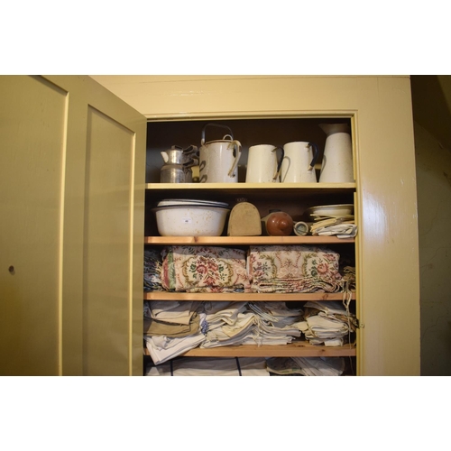 48 - Assorted domestic enamel wares, textiles and other items (the contents of a cupboard), removal cost ... 