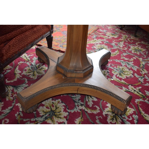 107 - An early Victorian rosewood centre table, the tilt top on an octagonal column and concave sided plat... 