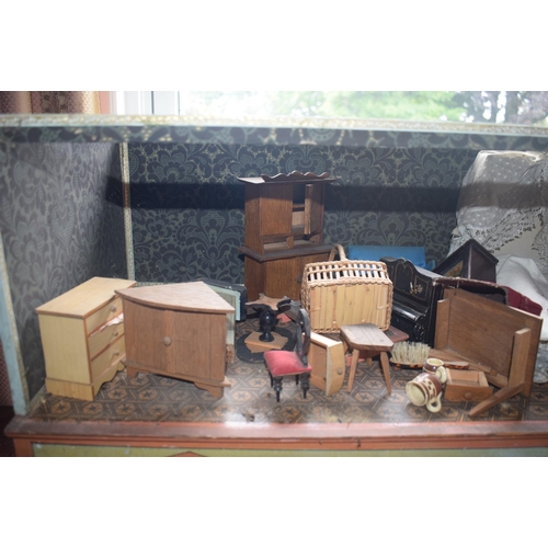 121 - A late 19th/early 20th century three storey doll's house, No 5, with a large group of assorted furni... 