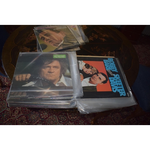 144 - A large quantity of assorted 33 rpm records, including country and western, film and others, a group... 