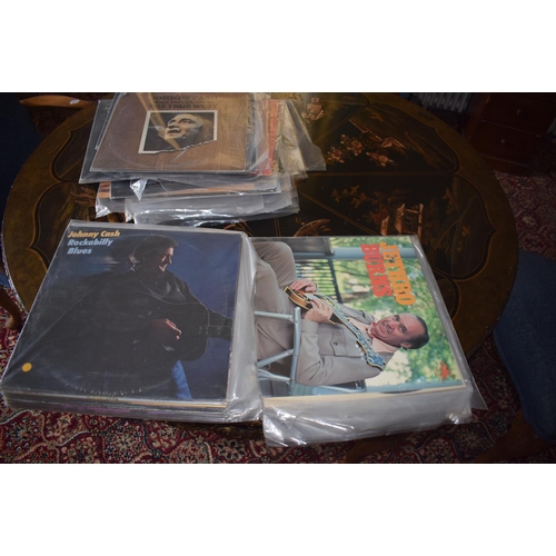 144 - A large quantity of assorted 33 rpm records, including country and western, film and others, a group... 