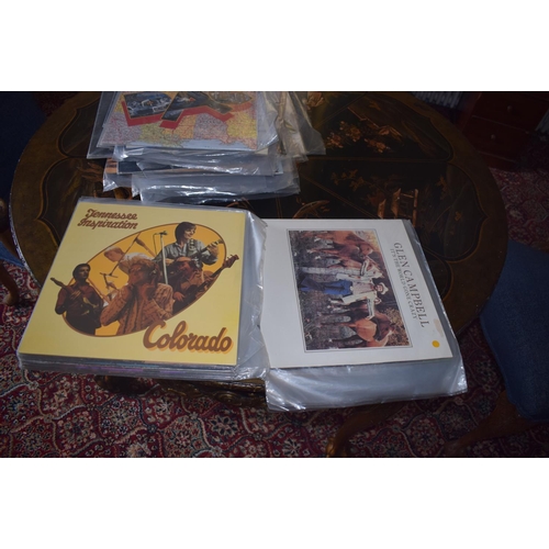 144 - A large quantity of assorted 33 rpm records, including country and western, film and others, a group... 