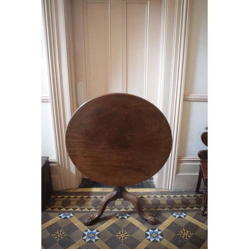 220 - A 19th century mahogany tripod table, on a vase turned column and leaf carved legs with claw and bal... 