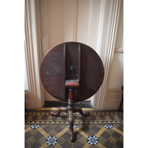 220 - A 19th century mahogany tripod table, on a vase turned column and leaf carved legs with claw and bal... 