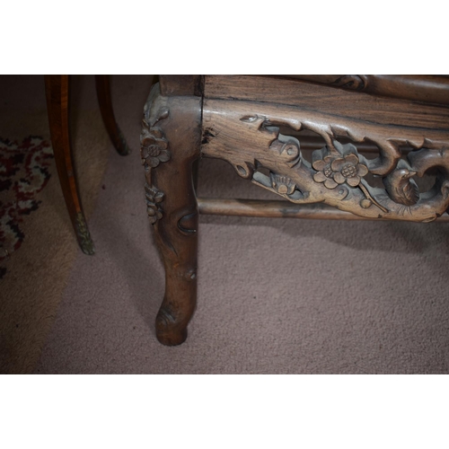 347 - A Chinese hardwood armchair, carved in relief and pierced with birds and blossom, on shaped legs, re... 