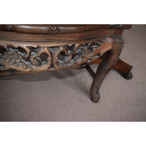 347 - A Chinese hardwood armchair, carved in relief and pierced with birds and blossom, on shaped legs, re... 