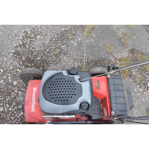 5 - A Mountfield self propelled petrol lawn mower, and a Stihl Wood Boss chain saw (2) removal cost C