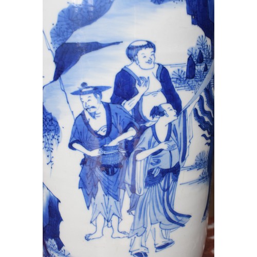 309 - A Chinese rouleau vase, decorated a man breathing fire with a dragon and other figures in underglaze... 