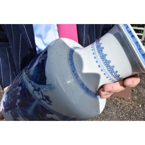 309 - A Chinese rouleau vase, decorated a man breathing fire with a dragon and other figures in underglaze... 