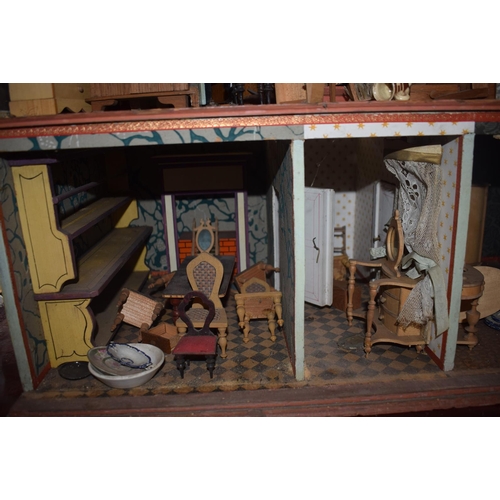 121 - A late 19th/early 20th century three storey doll's house, No 5, with a large group of assorted furni... 