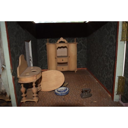 121 - A late 19th/early 20th century three storey doll's house, No 5, with a large group of assorted furni... 