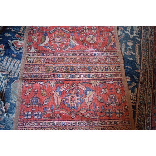 174 - A large carpet, with floral and geometric motifs on a blue ground, within a multi border, worn, fade... 