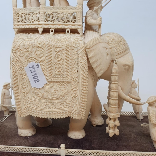 295 - A late 19th century carved ivory elephant, carrying a howdah, carrying two figures escorted by four ... 