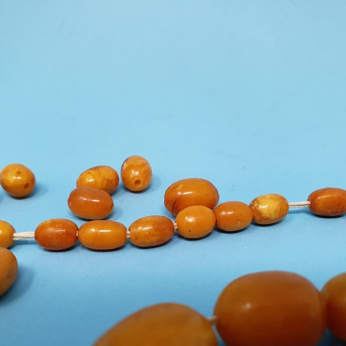 253 - A group of amber beads, removal cost A