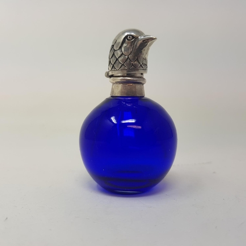 97 - A modern blue glass scent bottle, with mounts in the form of a bird's head, 5 cm high