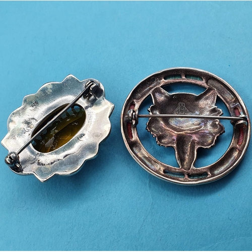 222 - A modern silver coloured metal brooch, inset with a yellow stone, another, embossed with a fox head ... 