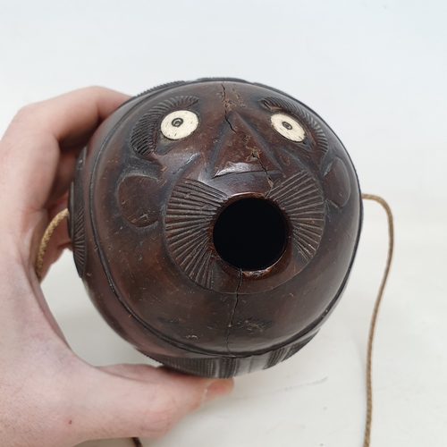 646 - A carved coconut bugbear flask, 14 cm wide