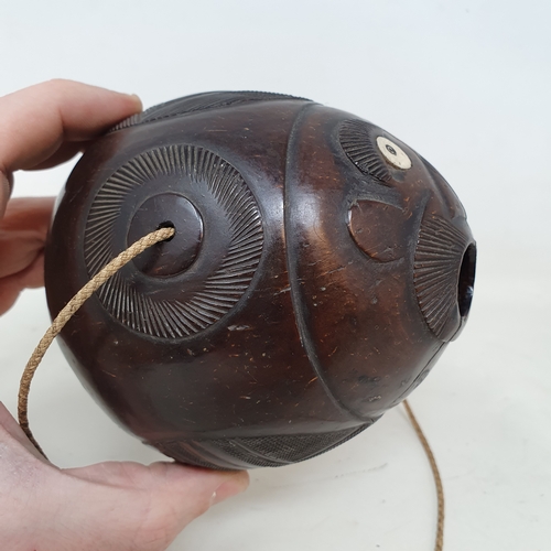 646 - A carved coconut bugbear flask, 14 cm wide