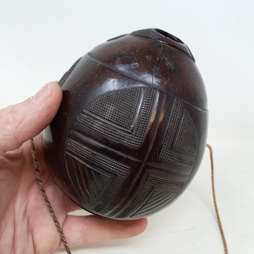 646 - A carved coconut bugbear flask, 14 cm wide