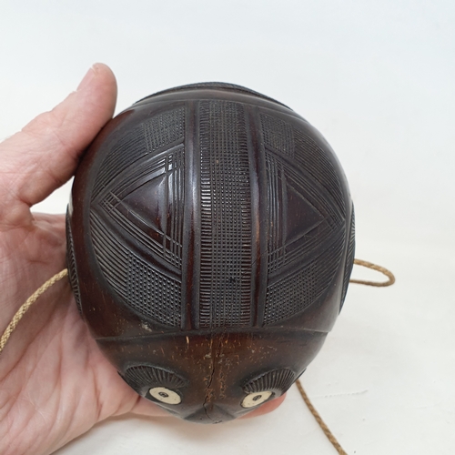 646 - A carved coconut bugbear flask, 14 cm wide