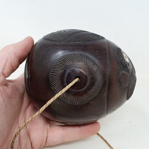 646 - A carved coconut bugbear flask, 14 cm wide