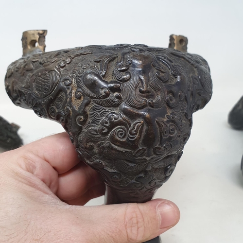 649 - A set of three Chinese bronze feet, decorated mythical beasts and foliage, 16 cm (3)